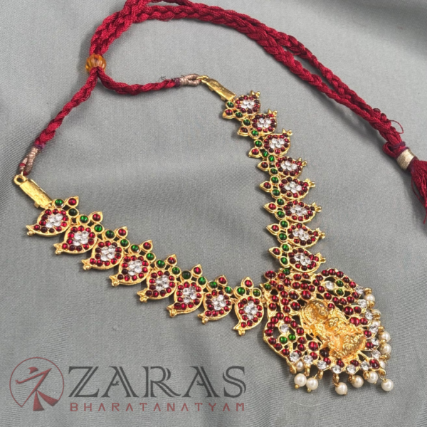 a necklace with a red string