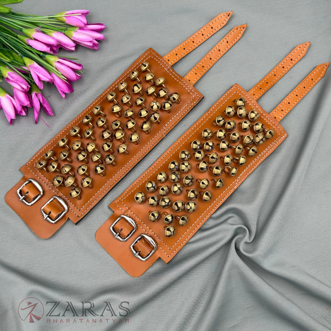 Golden Bharatanatyam anklet bells with adjustable straps, Traditional ghungroo for Bharatanatyam performances.